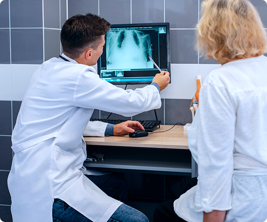 Los radiólogos miran una computadora con una radiografía de tórax y analizan el diagnóstico de un paciente